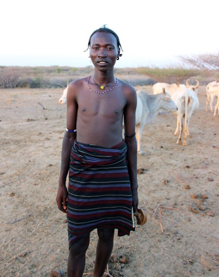 A head of the boma shows us where he keeps his livestock.