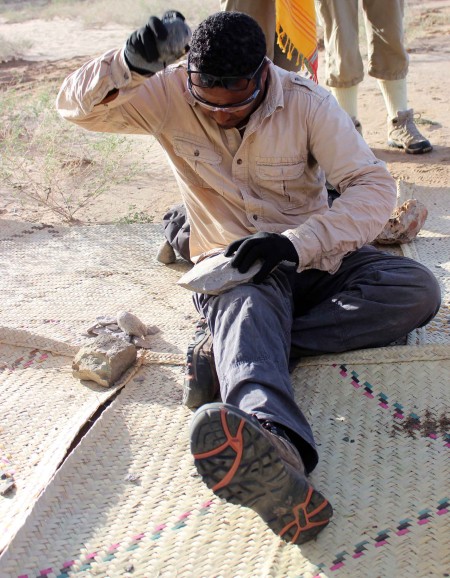 Tadele works hard at breaking apart this tough phonolite cobble - this material is no joke!