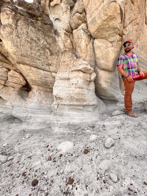Greg Henkes acting as scale in front of cross bedded tuff exposures