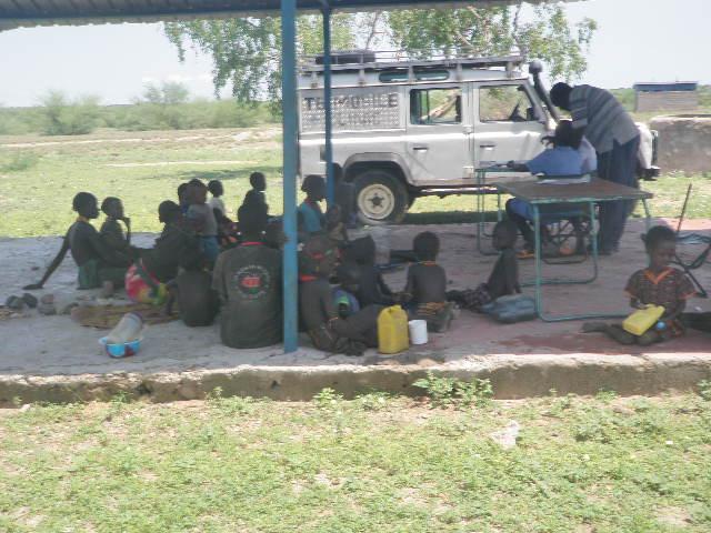 Mobile clinic staff attending to women and children