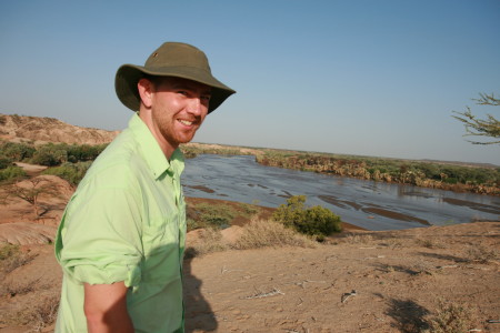 New Origins Field School Director, Dr. Jason E. Lewis, looking out over the fossiliferous exposures along the Turkwel river.