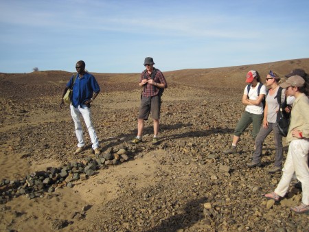 John Ekusi shows the field school the Middle Miocene excavation site that is being studied by Dr. Isaiah Nengo.