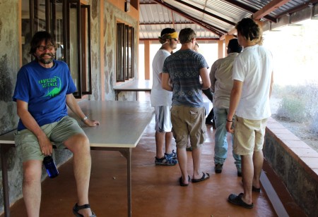 Prof. Fortelius watches the students complete the toilet paper timeline with amusement.