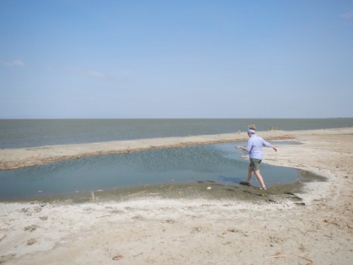 Kathryn measures the length of the beach by pacing (even through the lagoon)