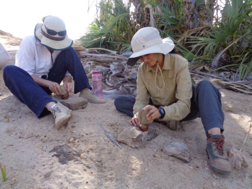 Natalie and Carla quickly pick up the proper methods used during nut processing