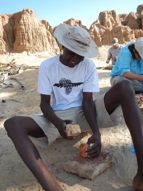 Francis, who works for TBI, showed the students how he often processes the palm nuts