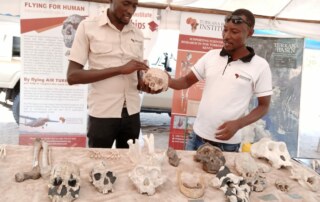 Martin Kirinya and Emmanuel Aipa showcase fossils in the TBI booth at the Tobong'u Lore Festival 2021